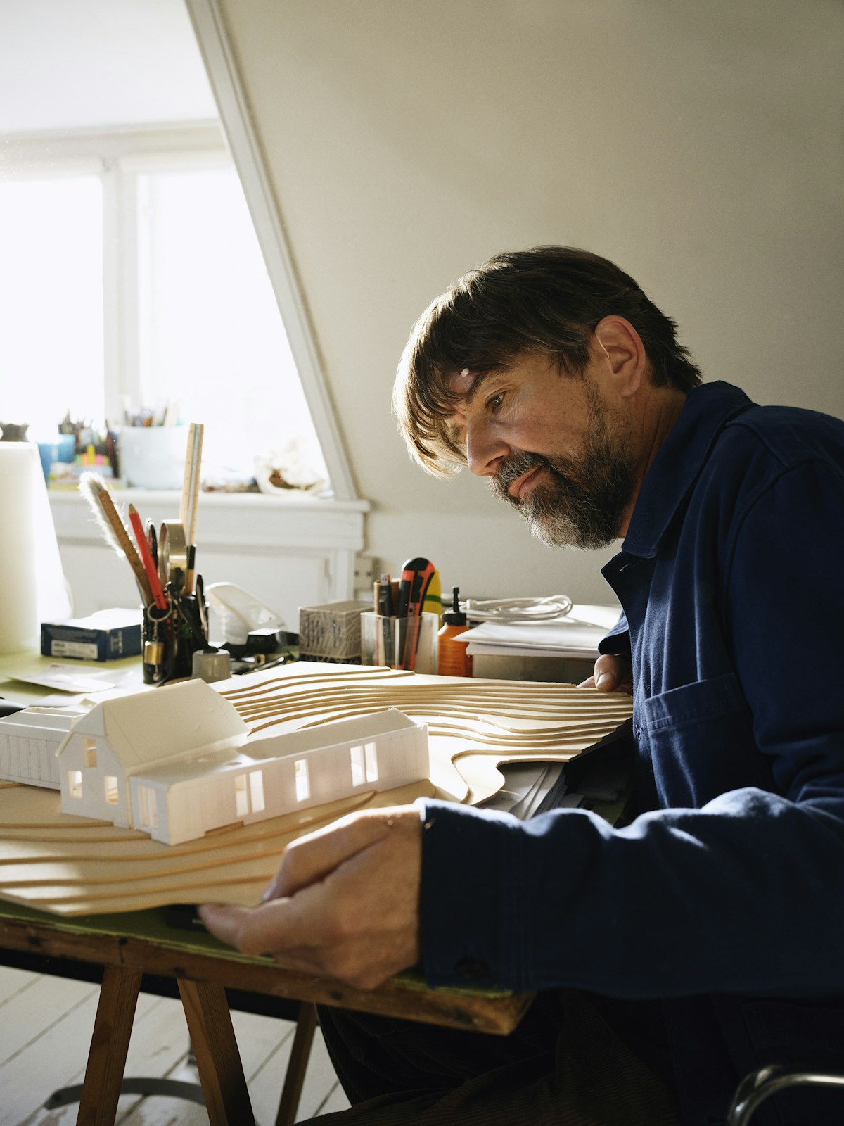 Architecte travaillant sur une maquette de maison dans l'atelier