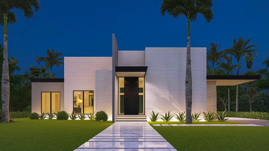 Façade blanche d'une maison contemporaine éclairée la nuit